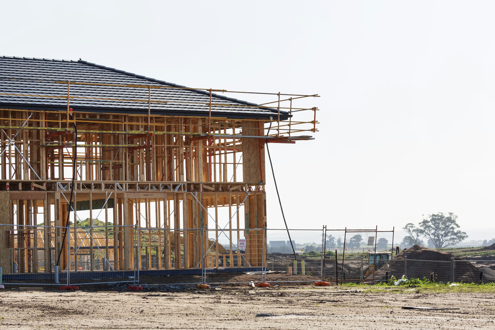 Residential new build under construction with scaffolding and timber frame