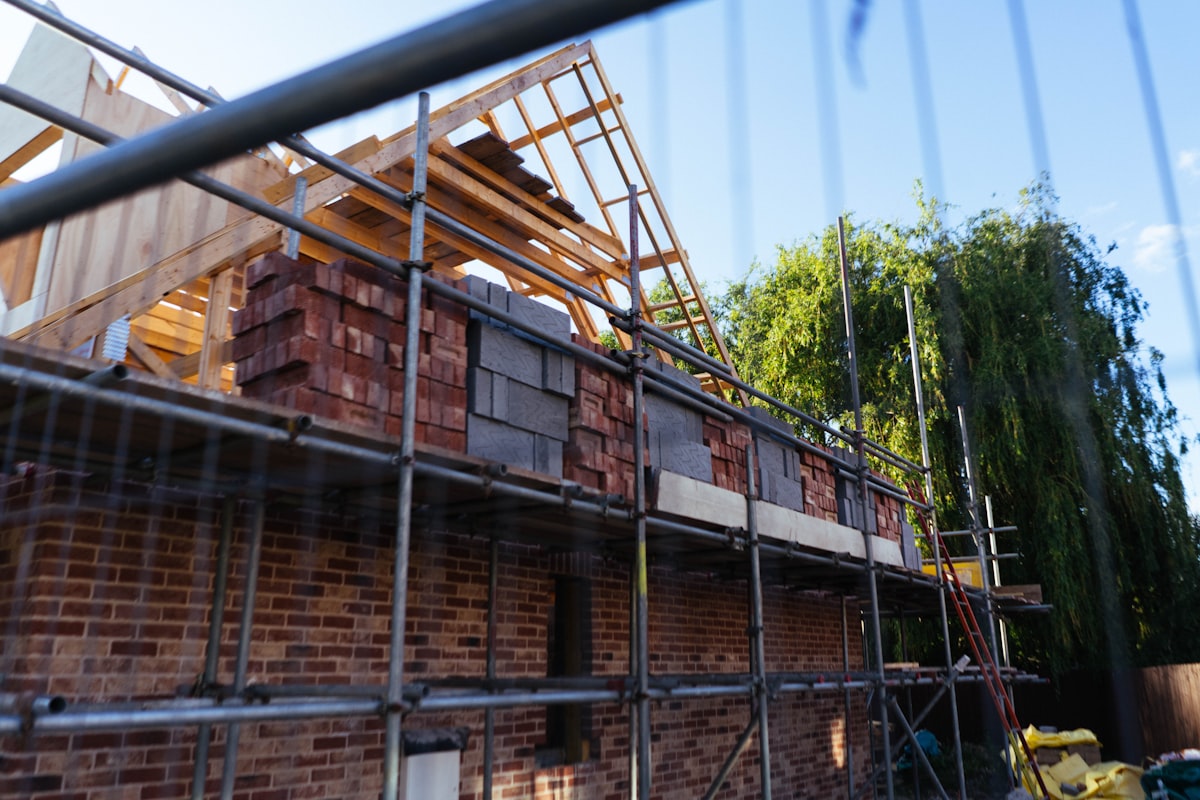 UK house under construction with scaffolding and brickwork